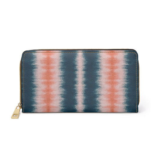Tie-dye patterned wallet with a gold zipper on a white background